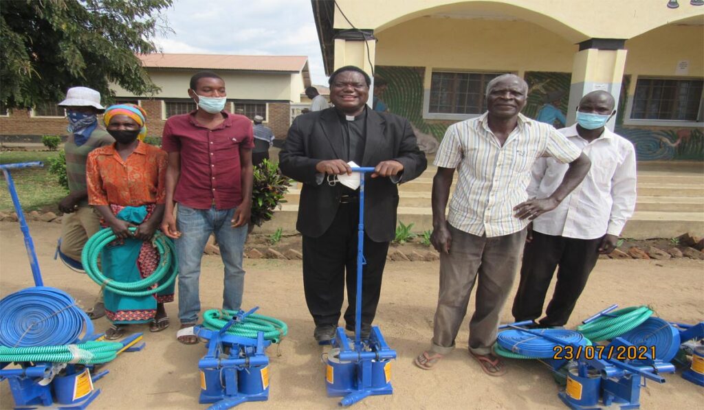 Rev. Fr. Dr. Joseph Kimu demonstrating on the use of the newly distributed treadle pumps
